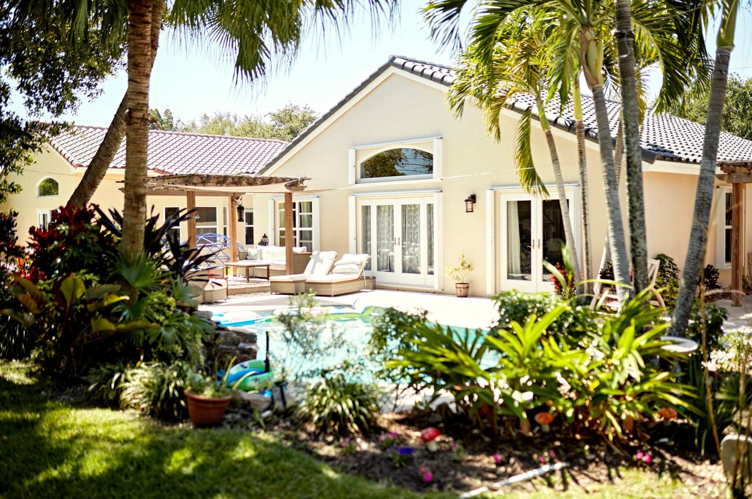 Tropical backyard with pool and patio