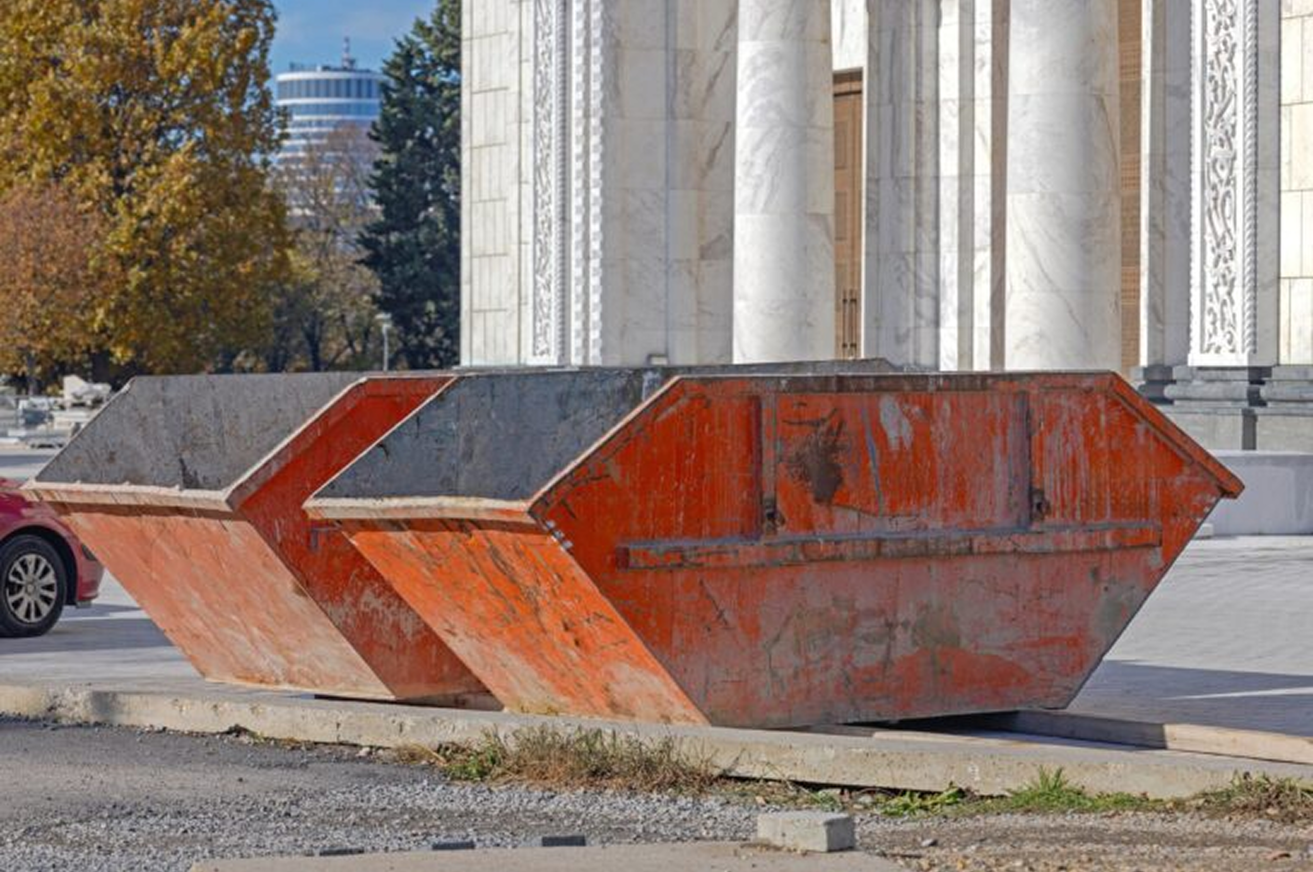 Orange dumpsters by a building